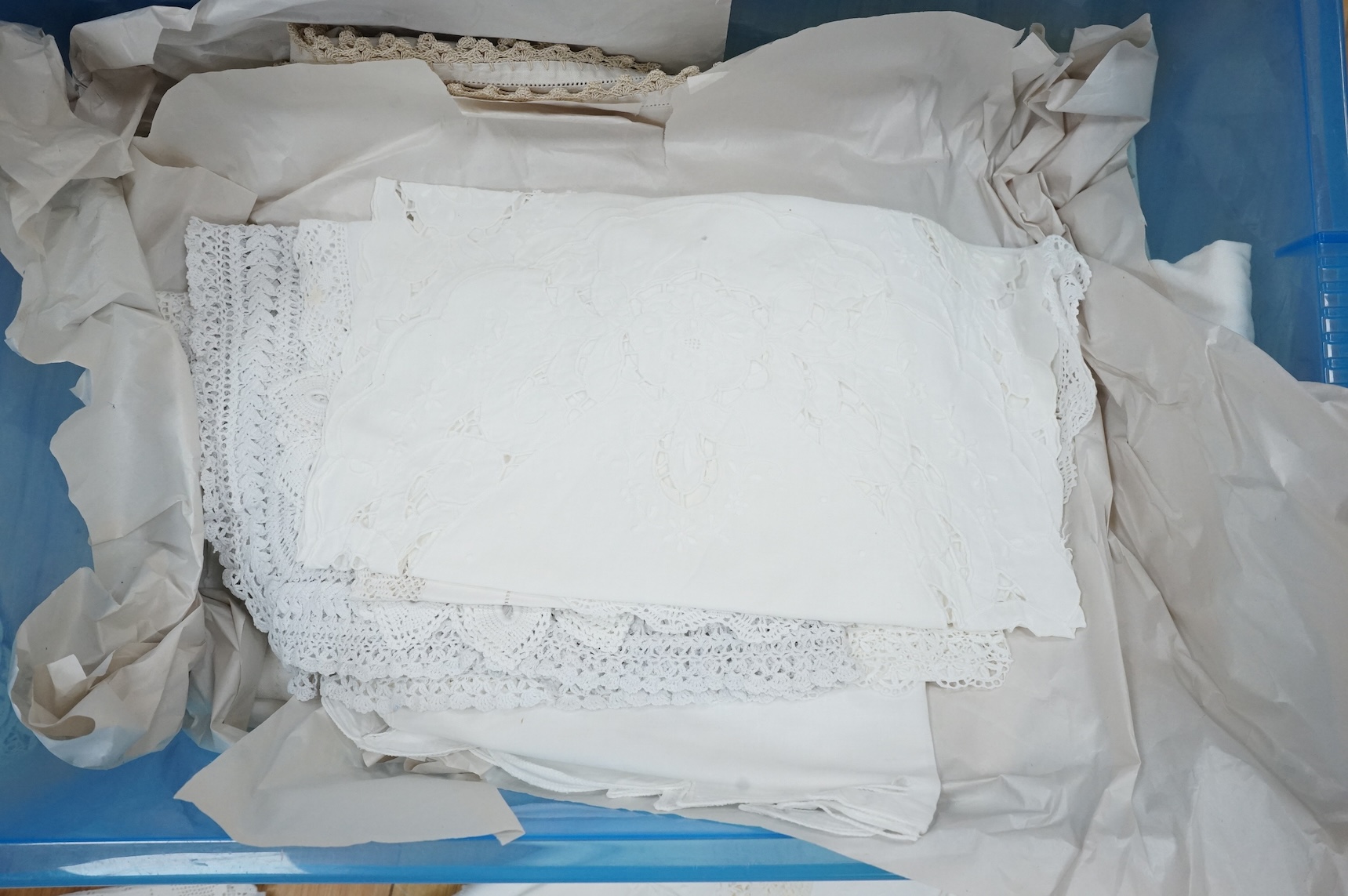 A collection of early 20th century and later crochet, cut work and drawn thread table linens and a large embroidered table cloth